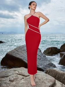 Close-up of red halter evening dress with silver rhinestone diagonal bands on high-stretch fabric