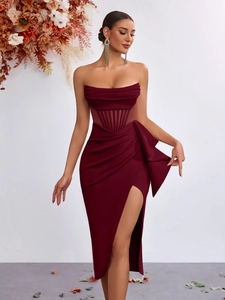 Detail of burgundy off-shoulder dress featuring a sheer corset waist and side bow accents