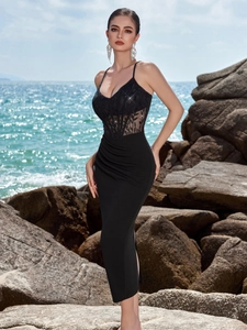 Detailed view of black lace embroidery and boned corset bodice on a sleek evening dress