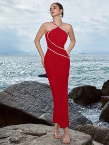 Detailed view of red halter evening dress featuring silver rhinestones and cross neckline
