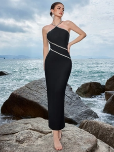 Detail of cross halter neckline and sparkling rhinestone stripes on black evening dress