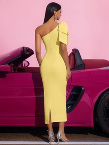 Detail of a bright yellow satin one-shoulder dress with a large bow and back zipper