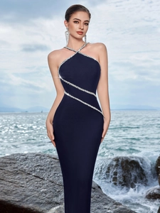 Detail of navy blue halter dress featuring sparkling rhinestone trims and mermaid silhouette