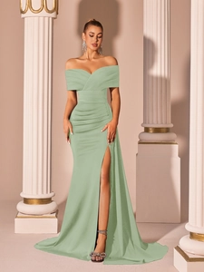 Detail of light green satin off-shoulder evening dress with elegant pleated waist and high slit