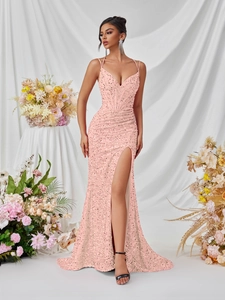 Detail of pink sequin evening dress featuring a boned waist corset and high side slit