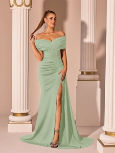 Close-up of pleated off-shoulder neckline on a light green satin formal evening gown