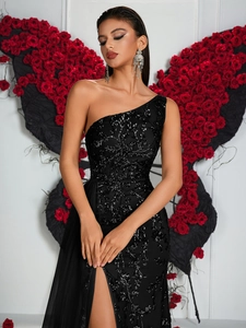Détail de robe de soirée noire asymétrique avec broderie à paillettes et fente haute