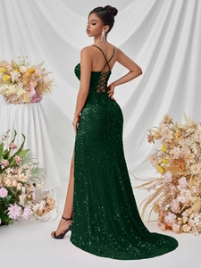 Deep green sequined evening gown featuring a lace-up back and elegant side slit design