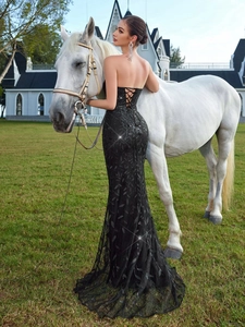 Elegant black sequin mermaid evening gown with lace-up back and high slit design