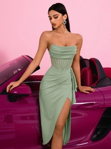 Elegant mint green strapless evening gown with corset waist and high slit by purple luxury car