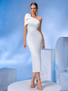Detail of elegant white one-shoulder dress with oversized bow decoration on left shoulder
