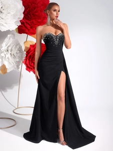 Close-up of pearl and rhinestone details on a black slit tube top evening dress