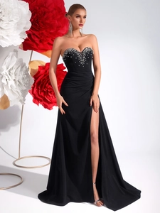 Close-up of elegant sweetheart neckline with hand-sewn pearls and crystals on black gown