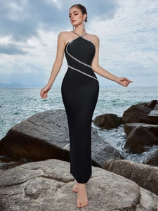 Elegant black halter evening gown with silver rhinestone cross trim and mermaid hemline