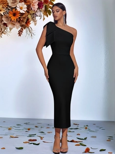 Detail of elegant black one-shoulder dress with sculptural bow and slim evening gown fit