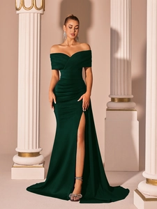 Detail view of the elegant emerald green off-shoulder satin gown with a high leg slit