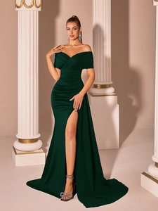 Detail of off-shoulder emerald green satin gown with pleated waist and high side slit