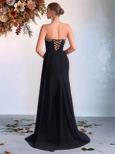 Elegant black strapless evening gown featuring corset back lacing and a fishtail train