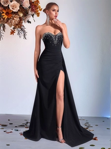 Elegant black strapless evening gown with sparkling pearl embellishments and a high side slit