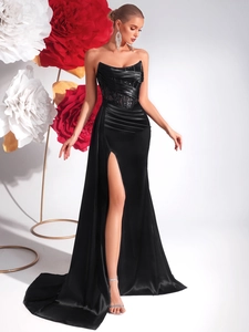 Detailed view of black strapless evening gown with corset waist and high slit design