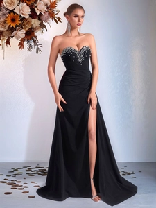 Elegant black strapless evening gown with side slit and sparkling rhinestone embellishments