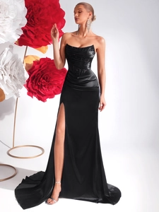 Detail of elegant black strapless evening dress with satin texture and high slit design