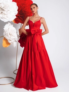 Elegant red V-neck satin gown with oversized bow accent and long flowing skirt