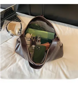 Top view of dark brown leather tote bag showing large capacity for laptop and makeup