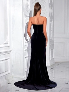 Elegant back view of slim fit black velvet strapless evening gown with thigh high slit