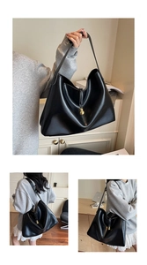 Detail of black Hobo tote bag with glossy finish and a prominent gold gourd pendant