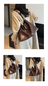 Deep brown tote bag styled with a beige trench coat showing spacious design and metallic charm
