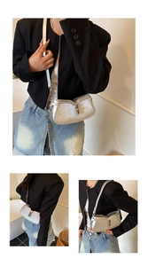 Close-up of silver wavy texture shoulder bag with metallic buckle and glittery finish