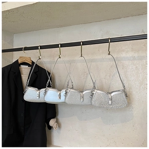 Detail of four silver baguette bags with various textures and stylish metallic clasps