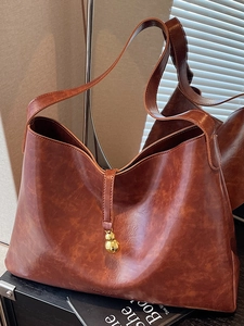 Retro dark brown tote bag with glossy leather and a golden gourd-shaped charm