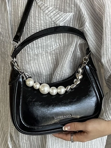 Chic black glossy crescent shoulder bag with pearl heart chain and silver hardware details