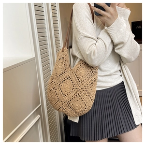 Detailed view of beige handmade crochet bag featuring hollow geometric diamond patterns