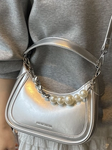 Silver crescent hobo bag with pearl chain and metallic finish for a trendy look