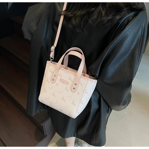 Detail of light pink tote bag with deer pattern, showing the adjustable shoulder strap