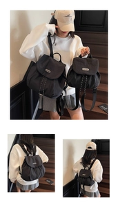 Detail view of black nylon drawstring backpacks in two sizes with metal brand logo