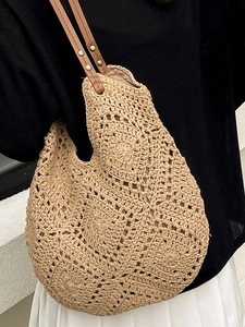 Minimalist woven straw shoulder bag with crochet flower patterns and leather handles