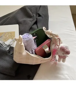 Detail of plaid dumpling bag interior showing space for umbrella, phone, and wallet