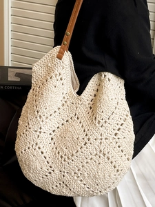 Handmade crochet woven shoulder bag with geometric cutouts and brown leather straps