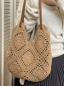 Bohemian crochet tote bag with brown leather straps and hollow knit pattern for beach use