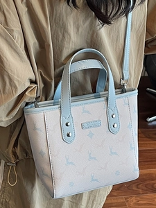 Chic tote bag with light blue deer pattern and top handles for daily fashion