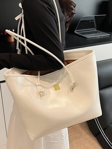 Stylish white glossy large capacity tote bag for women with gold logo and knotted handle