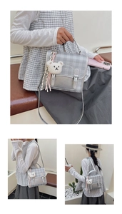 Detail of silver plaid backpack with adjustable strap and cute plush bear accessory