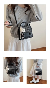 Detail view of the black and grey plaid backpack with a cute bear plush keychain charm