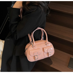Pink leather Boston bag with functional double front pockets and silver buckle detail