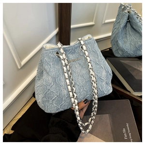 Detail of denim blue pleated bag with silver chain strap and JINGPIN metal logo