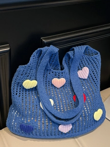 Blue crochet tote bag with colorful knitted hearts for summer beach or commute